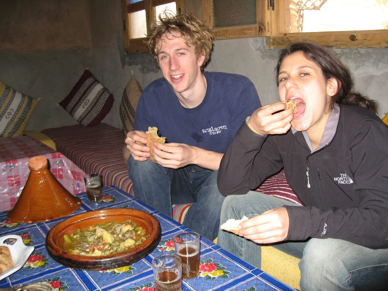 Trevor and Heidi eating tangine in a Berber farmhouse outside Agdz.