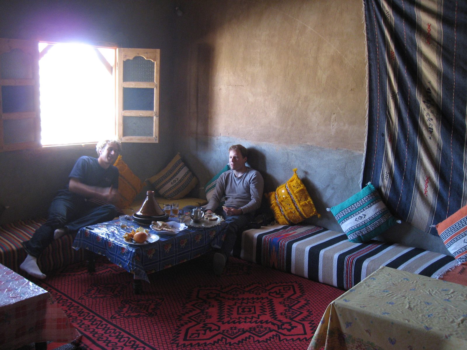 Trevor in the recumbent dining position, and John eating a Berber tangine lunch.
