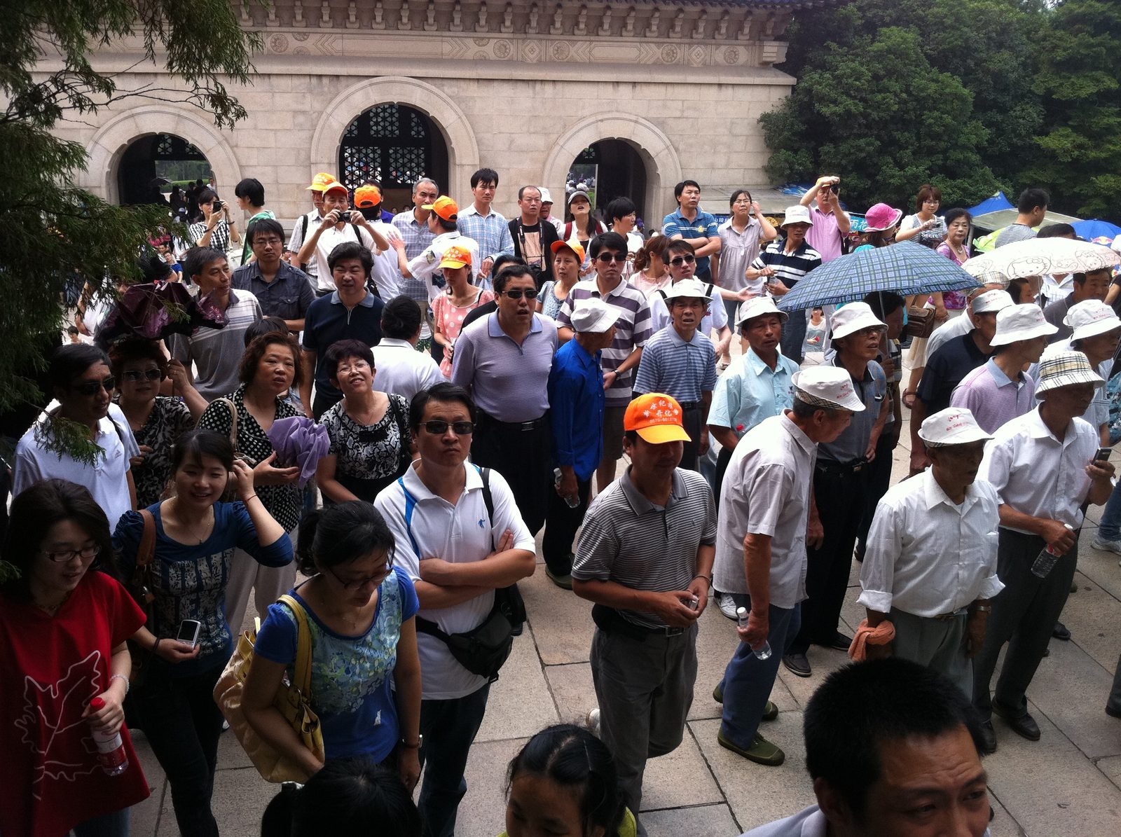 Tourists reading some inscriptions on the other side of the mausoleum gate.