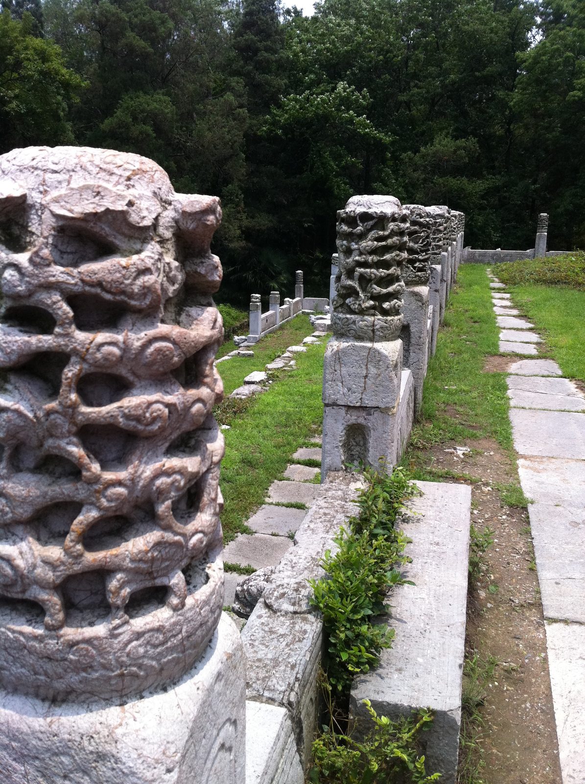 The mausoleum grounds were a vast complex of buildings in various states of archeological...