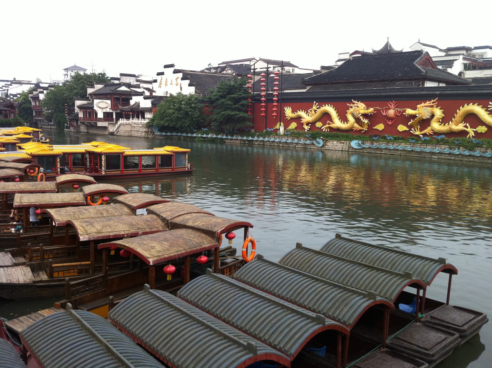 River boats and wall with Chinese dragons.