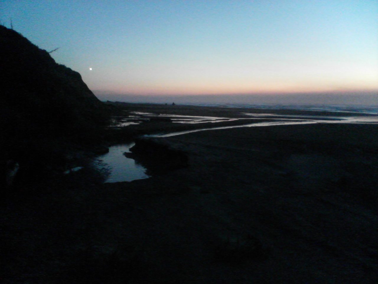 Oregon coast sunset on the beach of the Fields' house.  Moon at left.