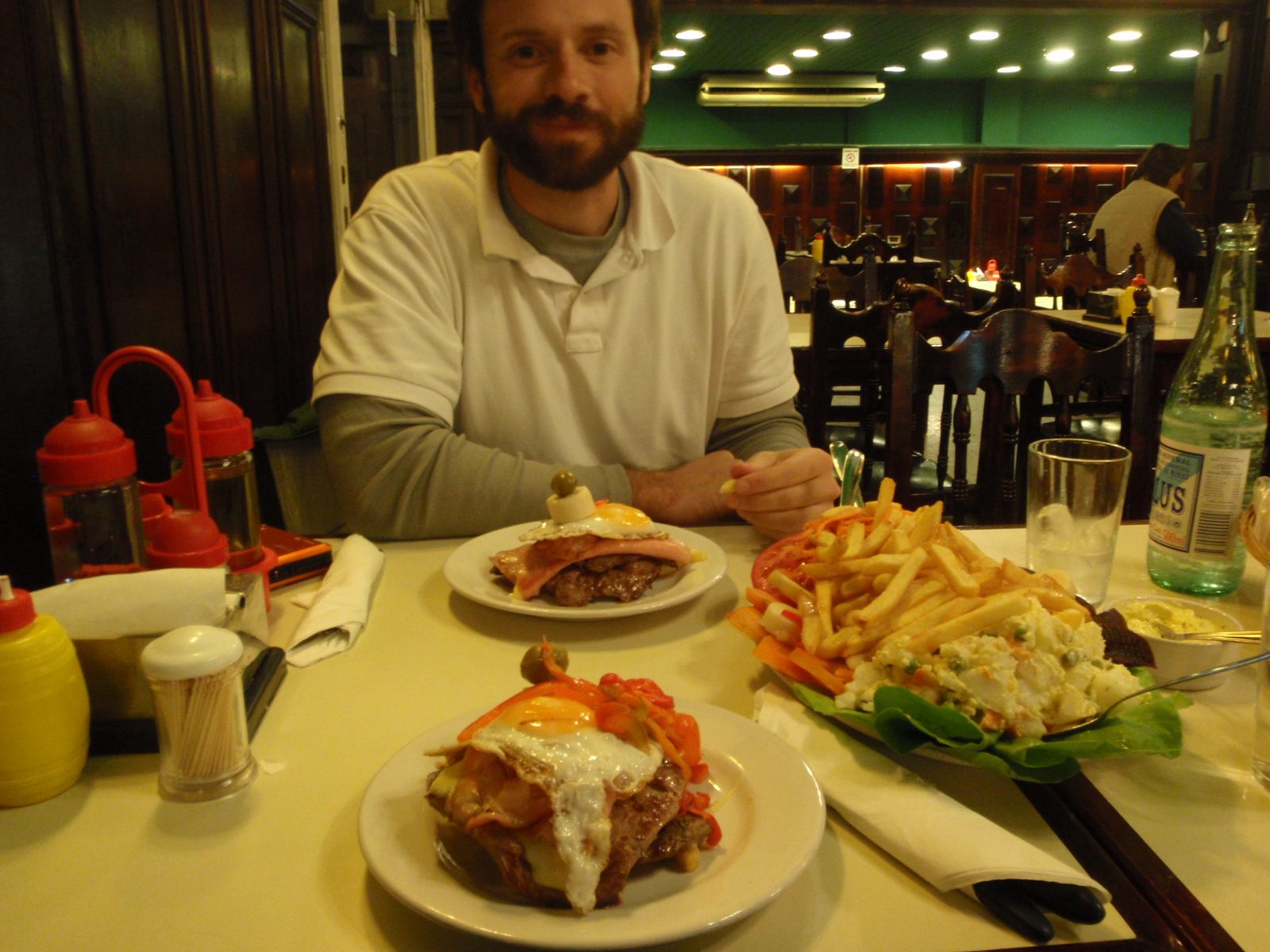 Serving number one.  Chivito contains, french fries, potato salad, beets, lettuce, tomato,...