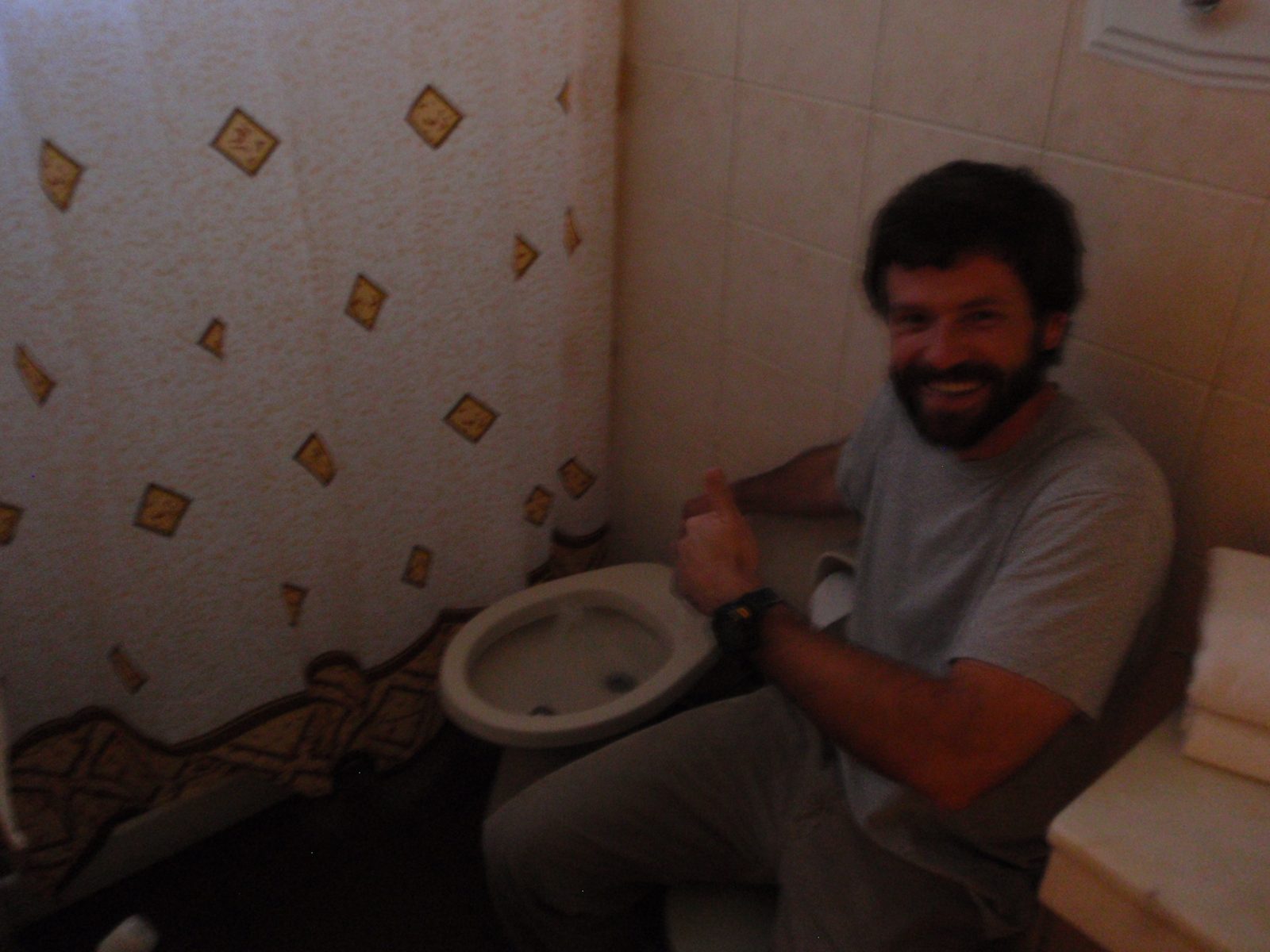 Jay testing the plumbing in our overpriced tourist trap hotel.