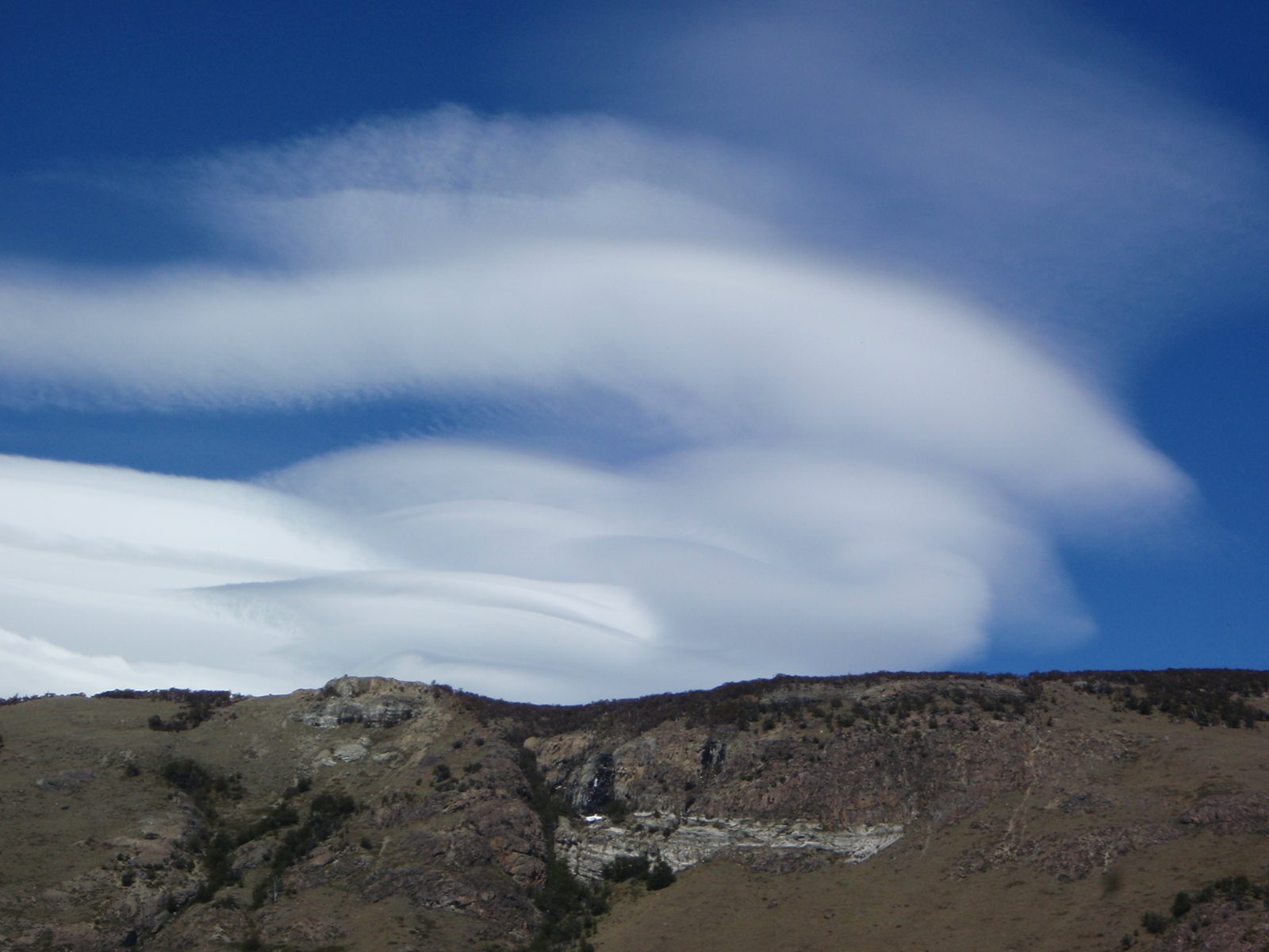 These UFO-like clouds are formed by very high winds, 130+ mph!  Patagonia is extremely windy...