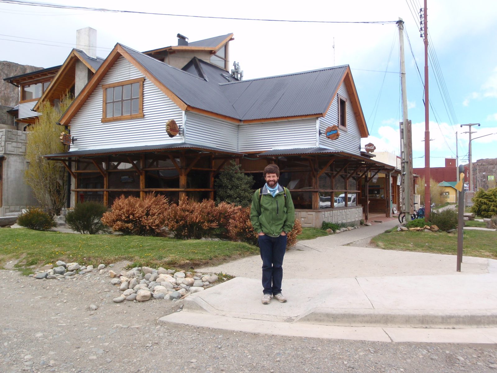 Jay, standing in front of a pizza parlor with a very interesting stainless steel cladding on the outside.