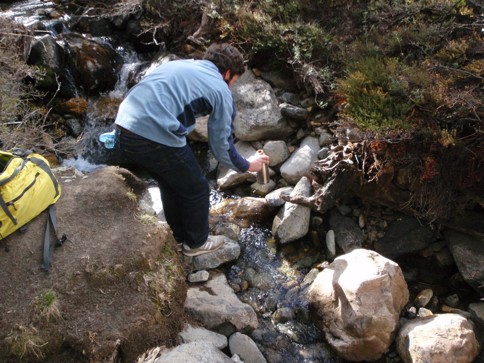 Filling our water bottles from an icy stream
