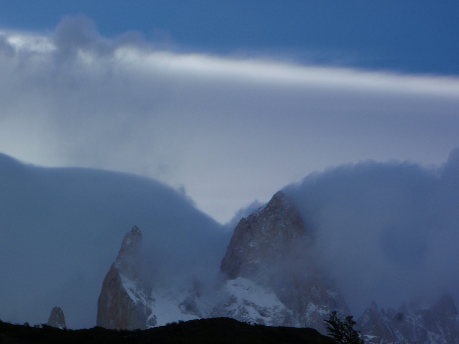 Perfectly blue sky up top, and raging snow storm on the mountain itself.