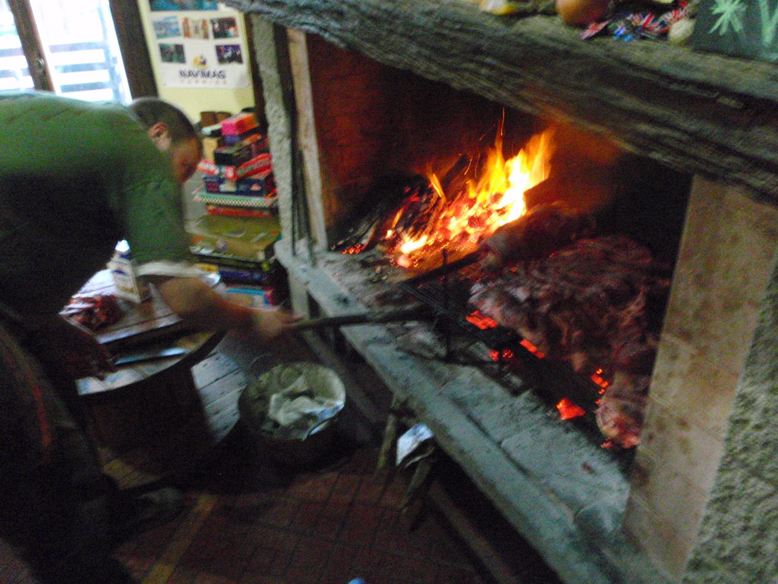 Martin stokes the fire for a massive barbecue. Apparently he shot the cow now cooking away on...