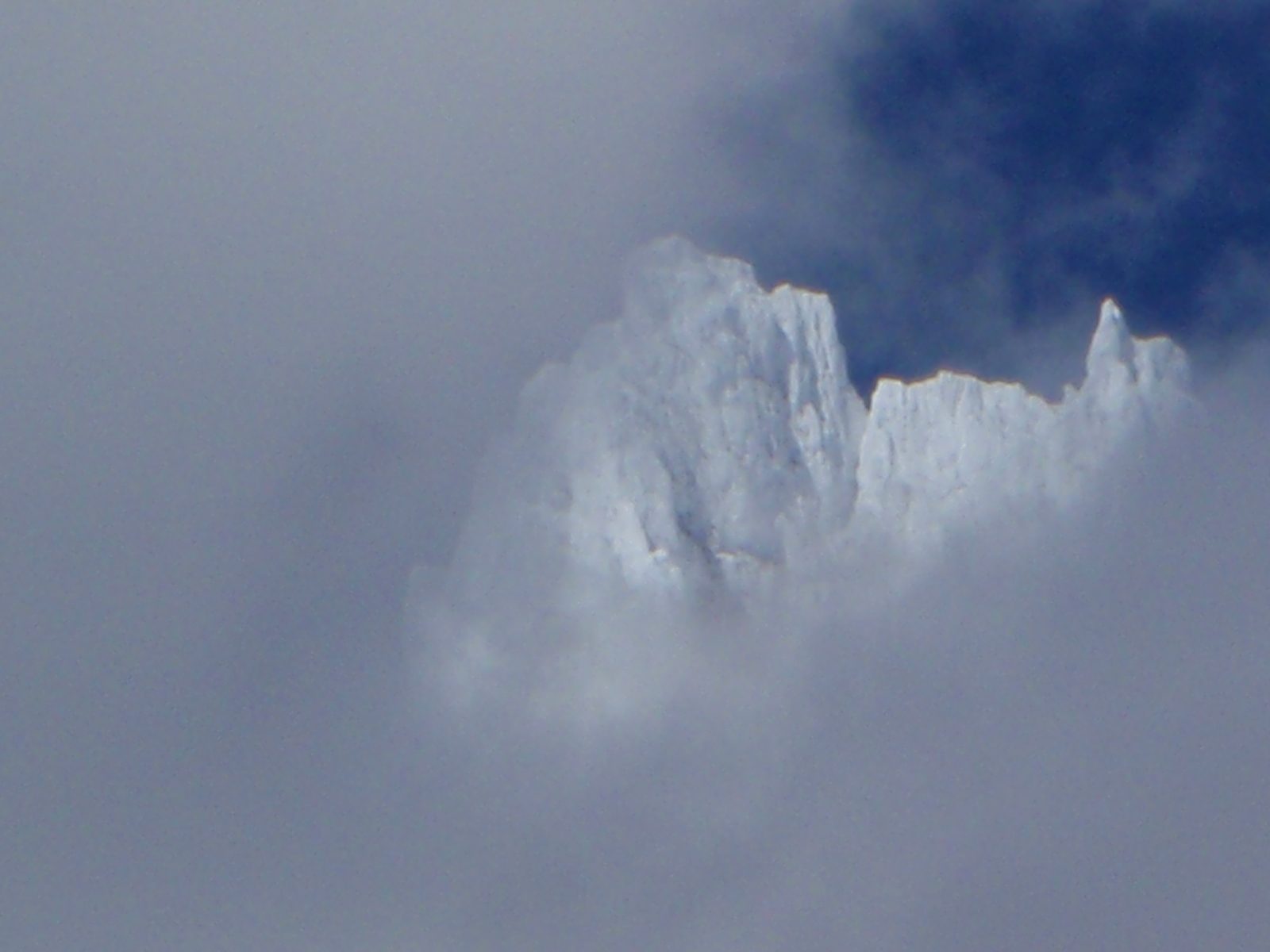 Cool shot of very high mountains between the clouds.