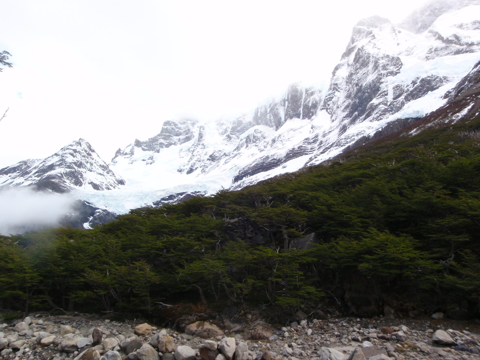 The glacier to the west comes into sharper focus as the clouds clear.