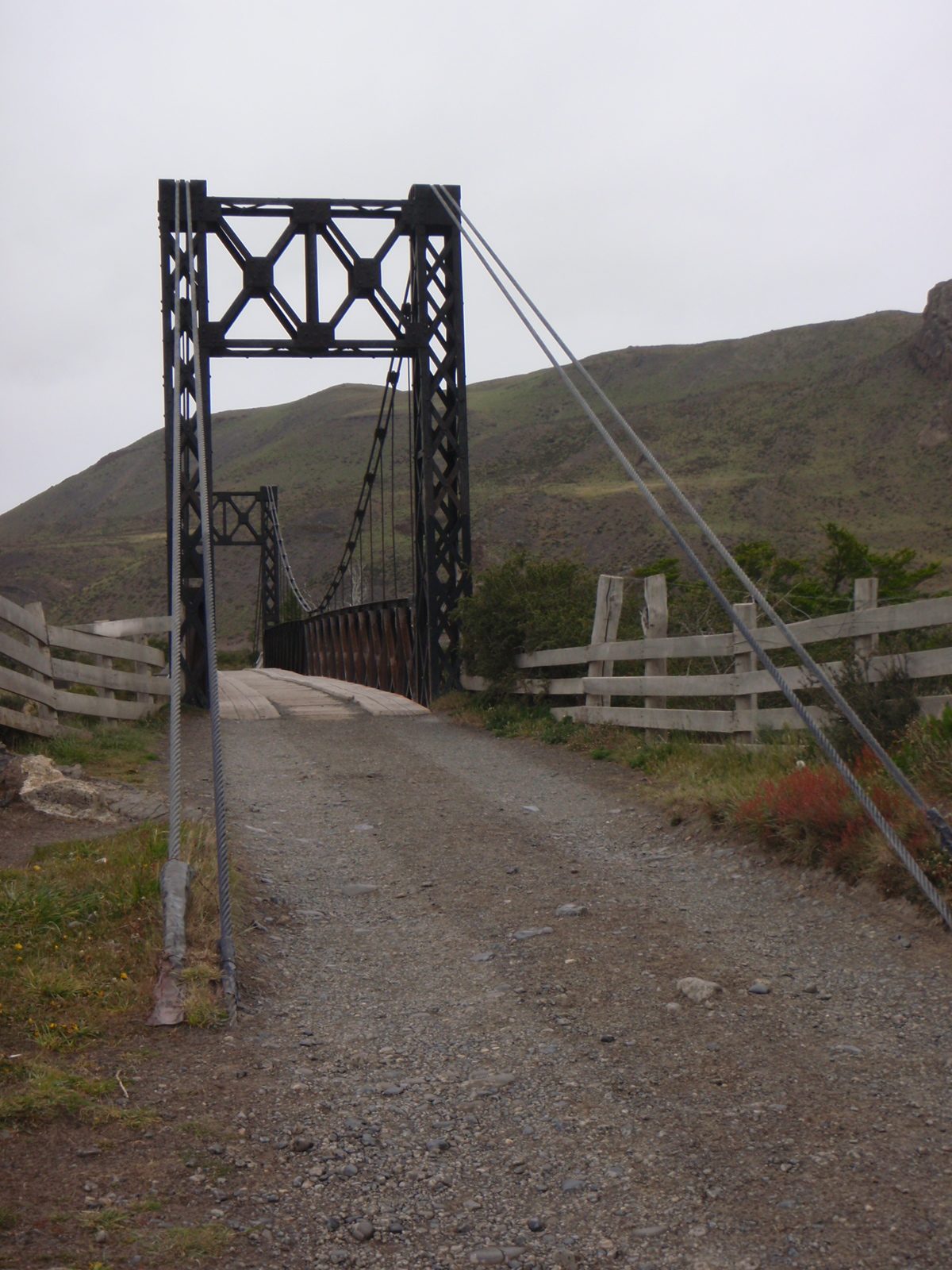 Suspension bridge in middle of nowhere Torres Del Paine National Park. Single lane, wooden deck....