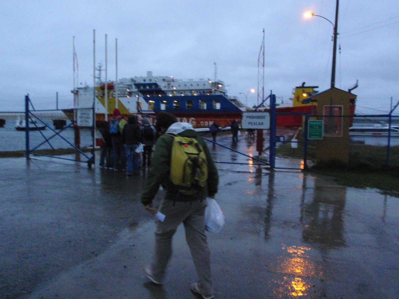 Here is our colorful boat! The rain had not let up one bit so this seemed like a long walk with...