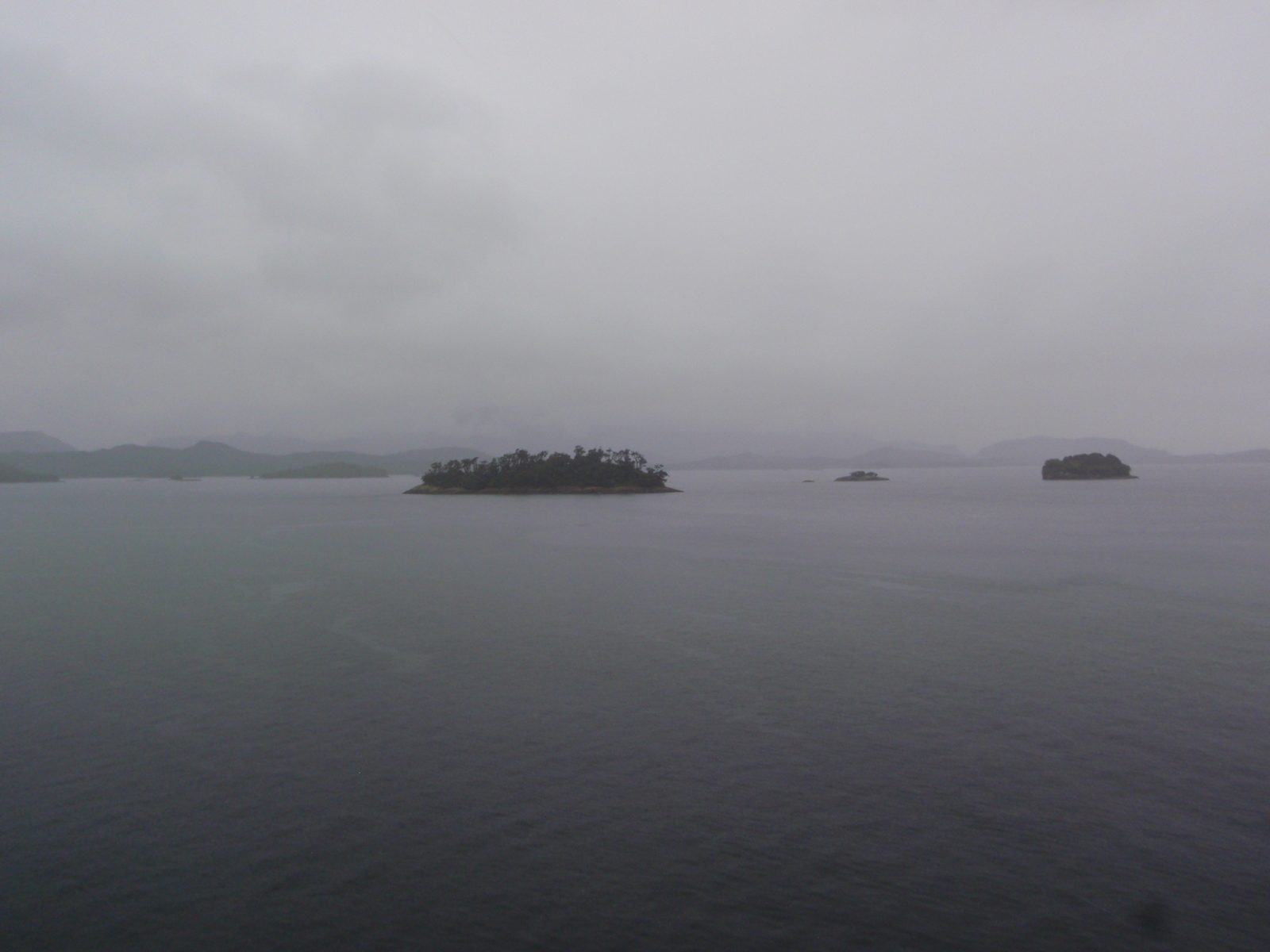Some pretty islands going by in the mist and fog.