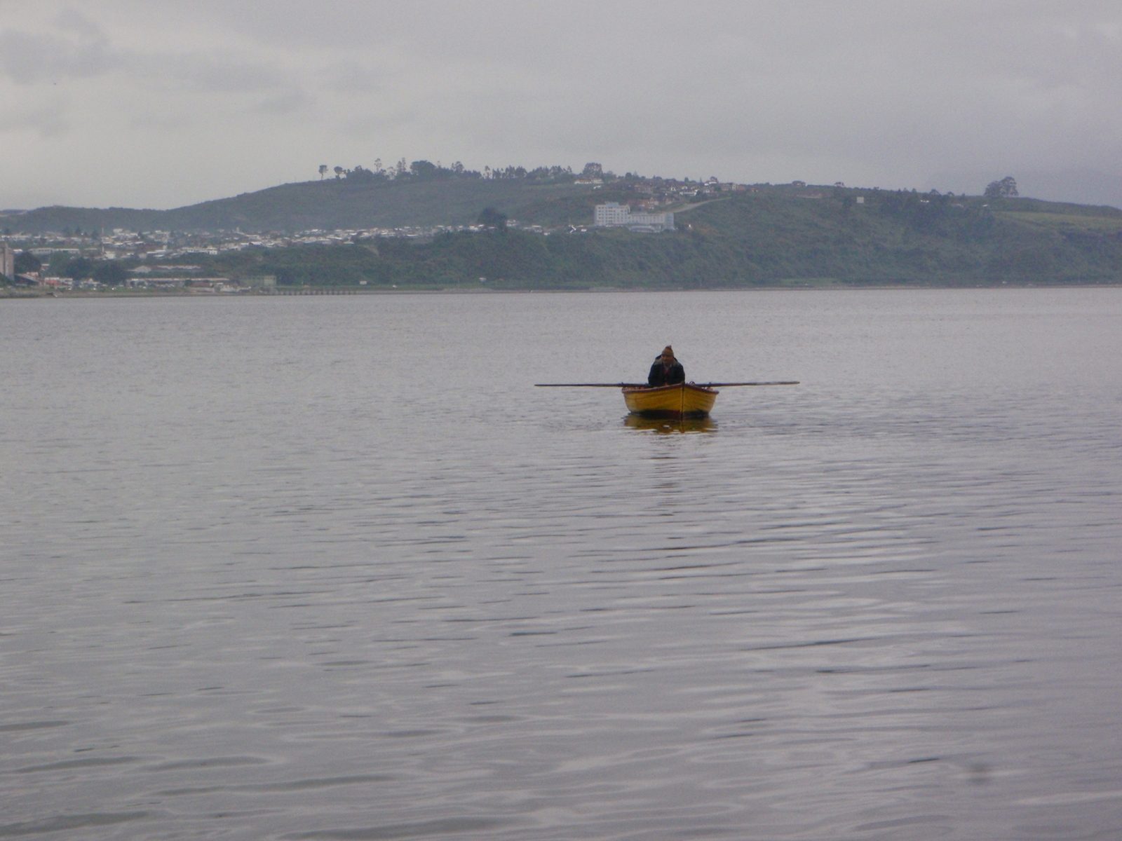 A lone fisherman in the harbor. Seems like a peaceful, albeit somewhat impoverished lifestyle.
