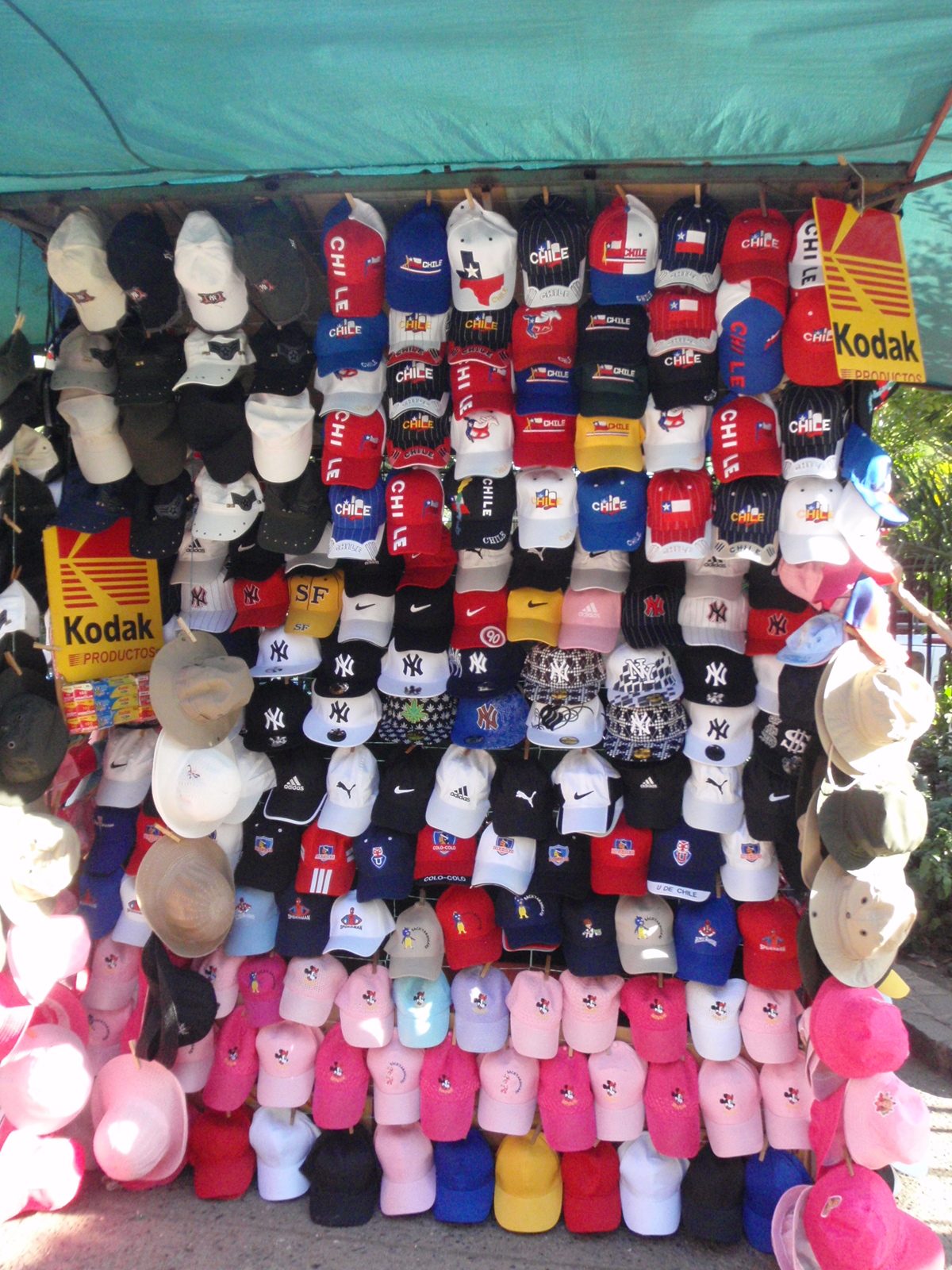 Hats for sale. The Chilean flag and Texan flag are very similar, but it is unclear on what...