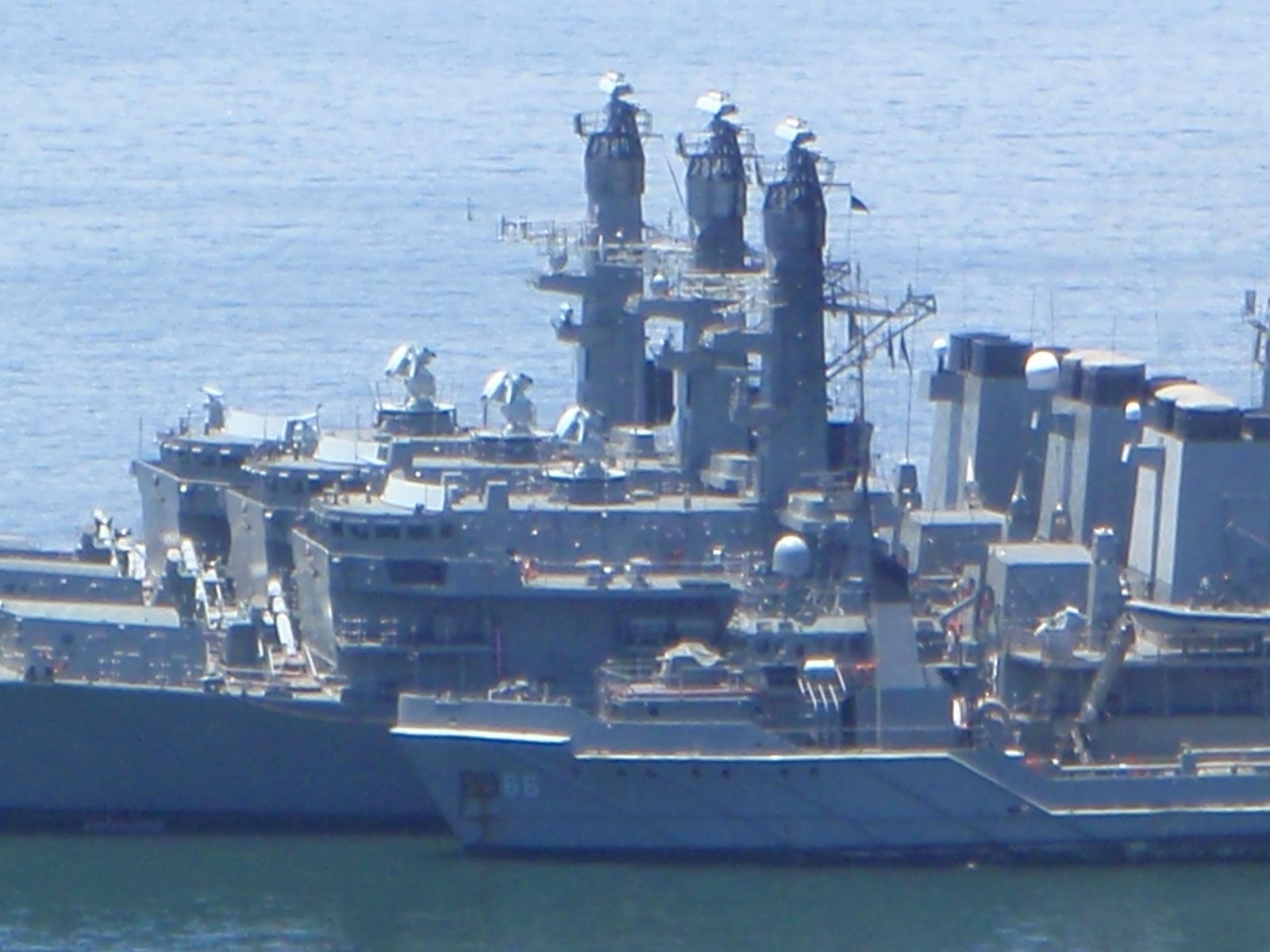 Naval ships moored in the harbor.