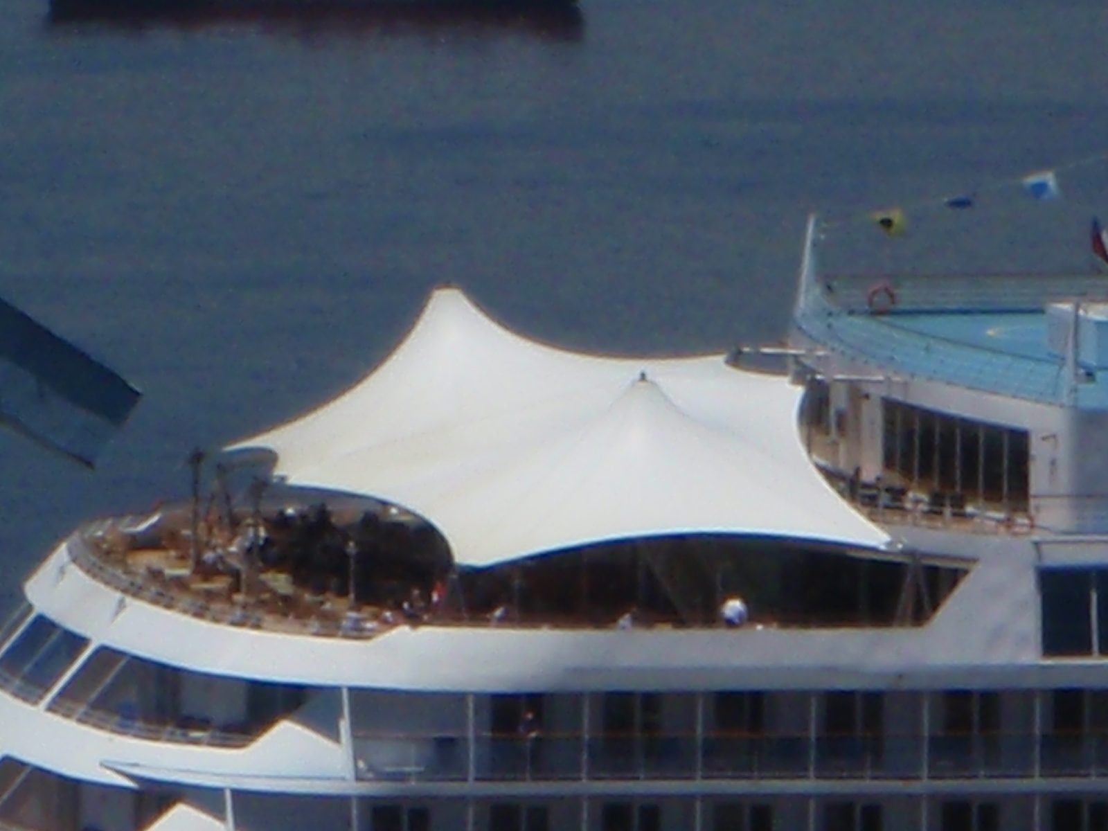 People enjoying brunch or whatever on the deck of a cruise ship.