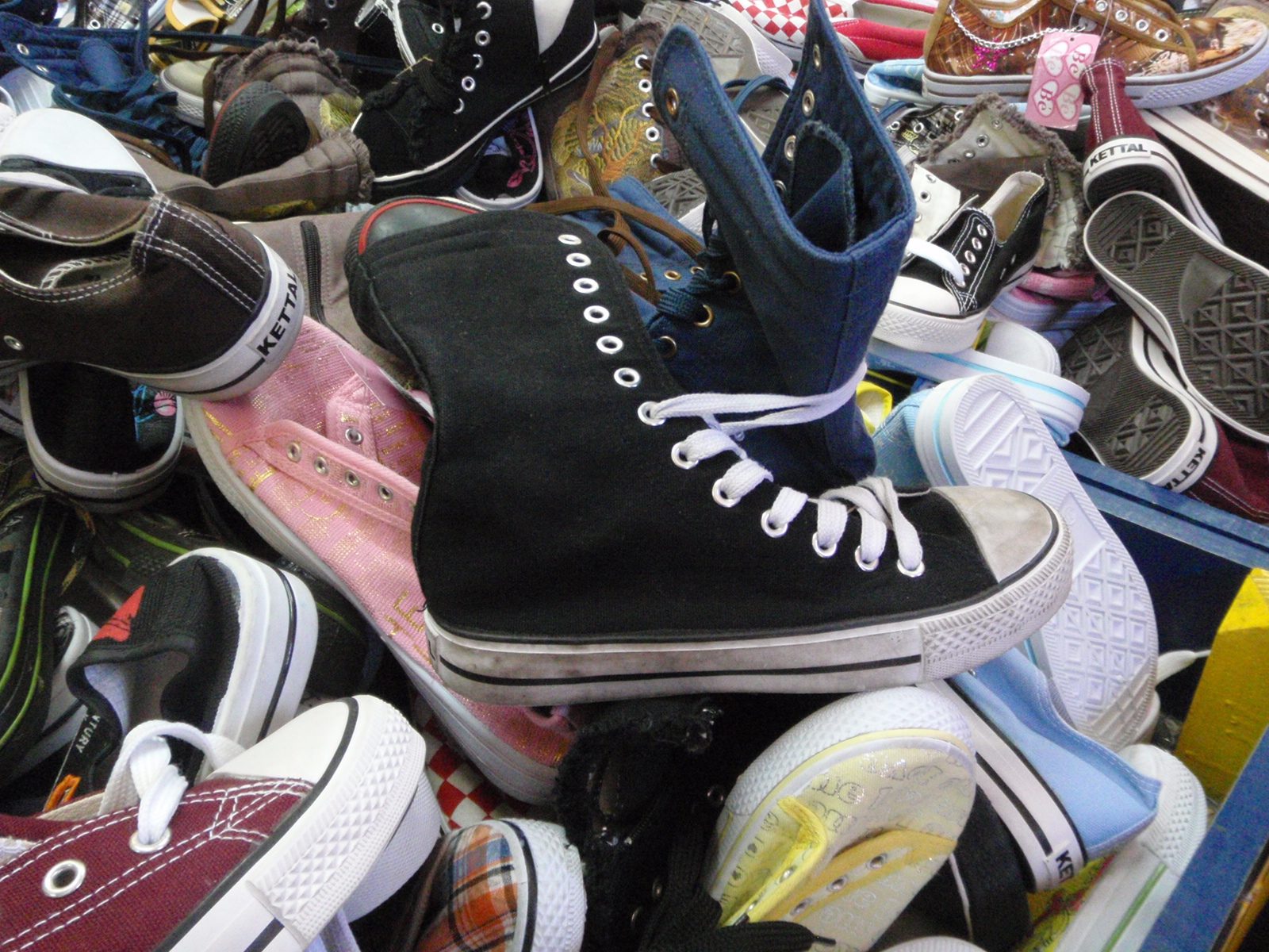Piles of knock-off Chuck Taylors, including some tempting knee-high Chucks.