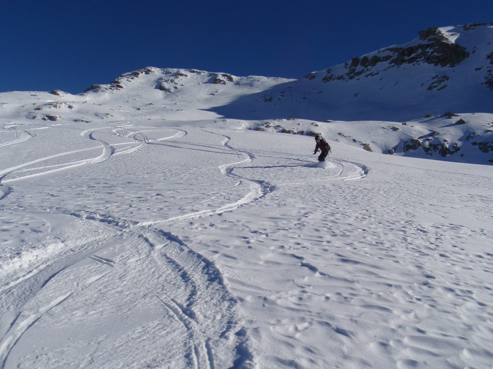 Monica snowboarding the backcountry on Catherine's splitboard.