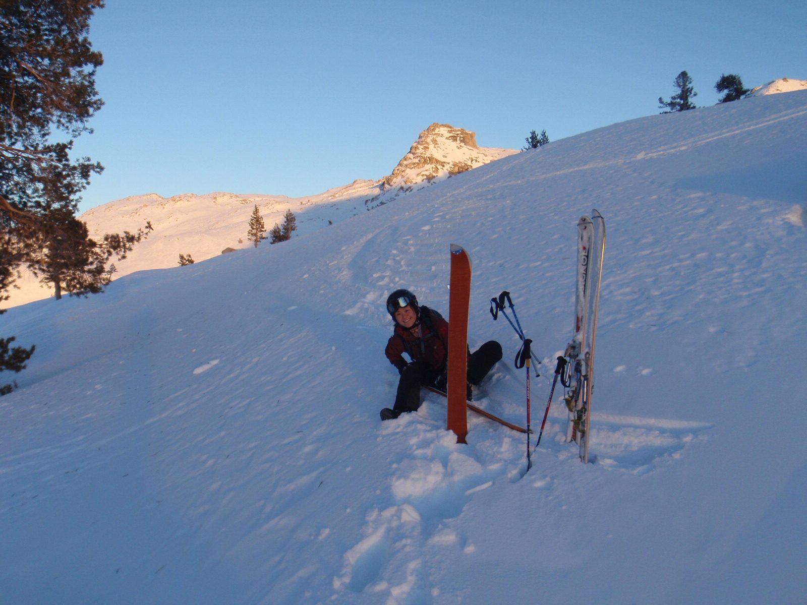 Monica, taking off the splitboard to watch the sunset. Matterhorn in the background.