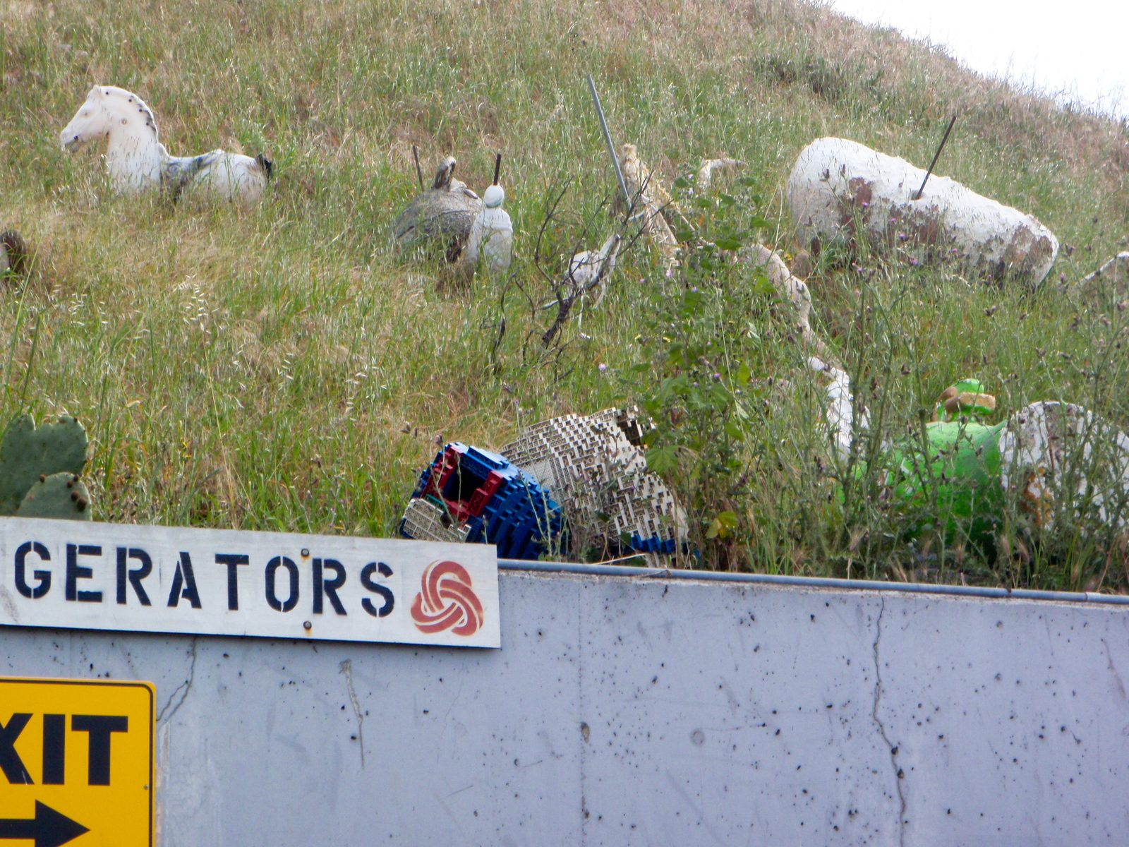 Up on the hill, workers toss interesting items that have been thrown away.  This appears to be a...