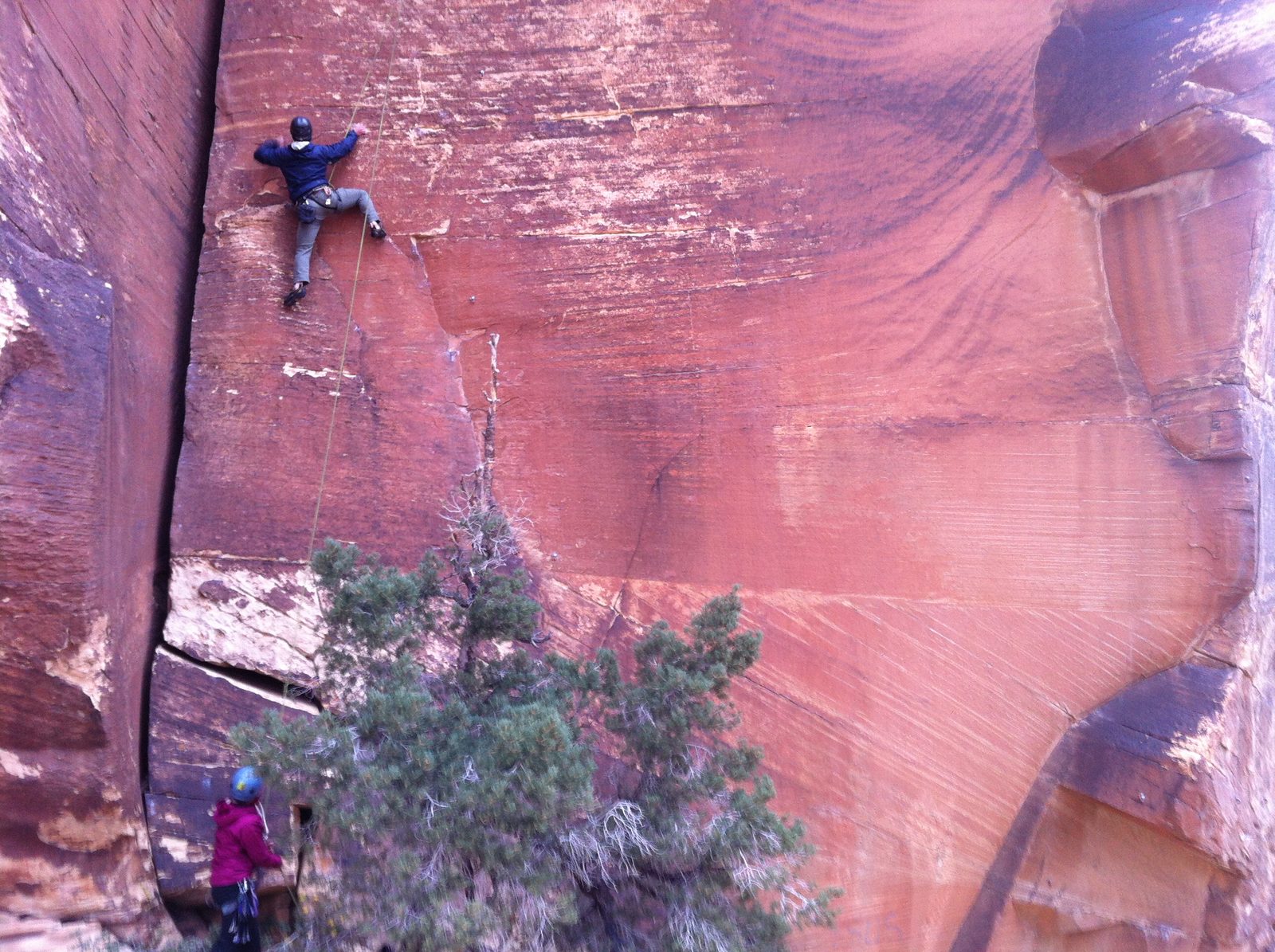 Alex, trying some difficult (easy 5.11?) face climbing next to Chrysler Crack. Monica belays (at bottom).