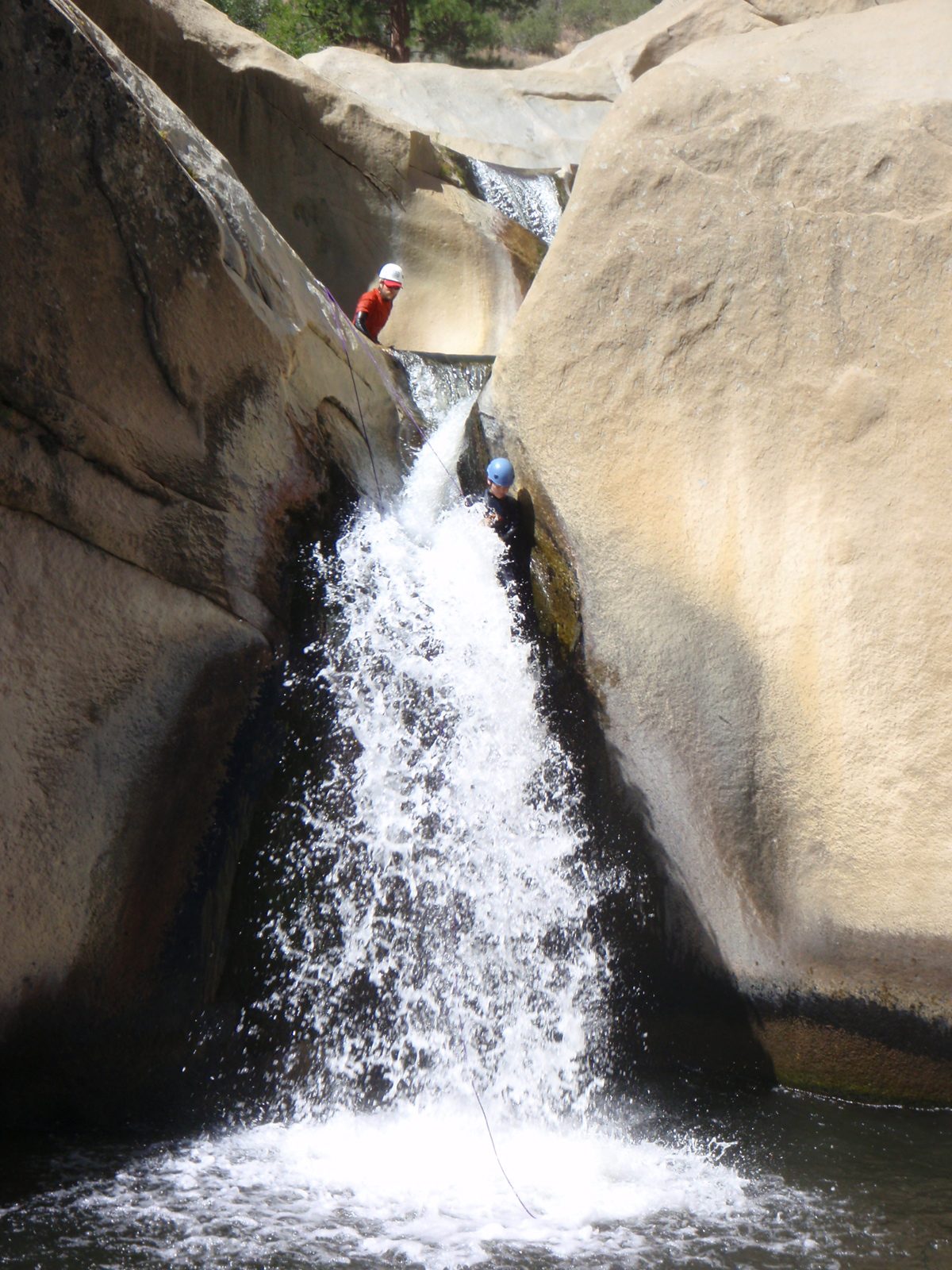 Monica rappelling between the fourth and fifth teacup.  John looks from above.