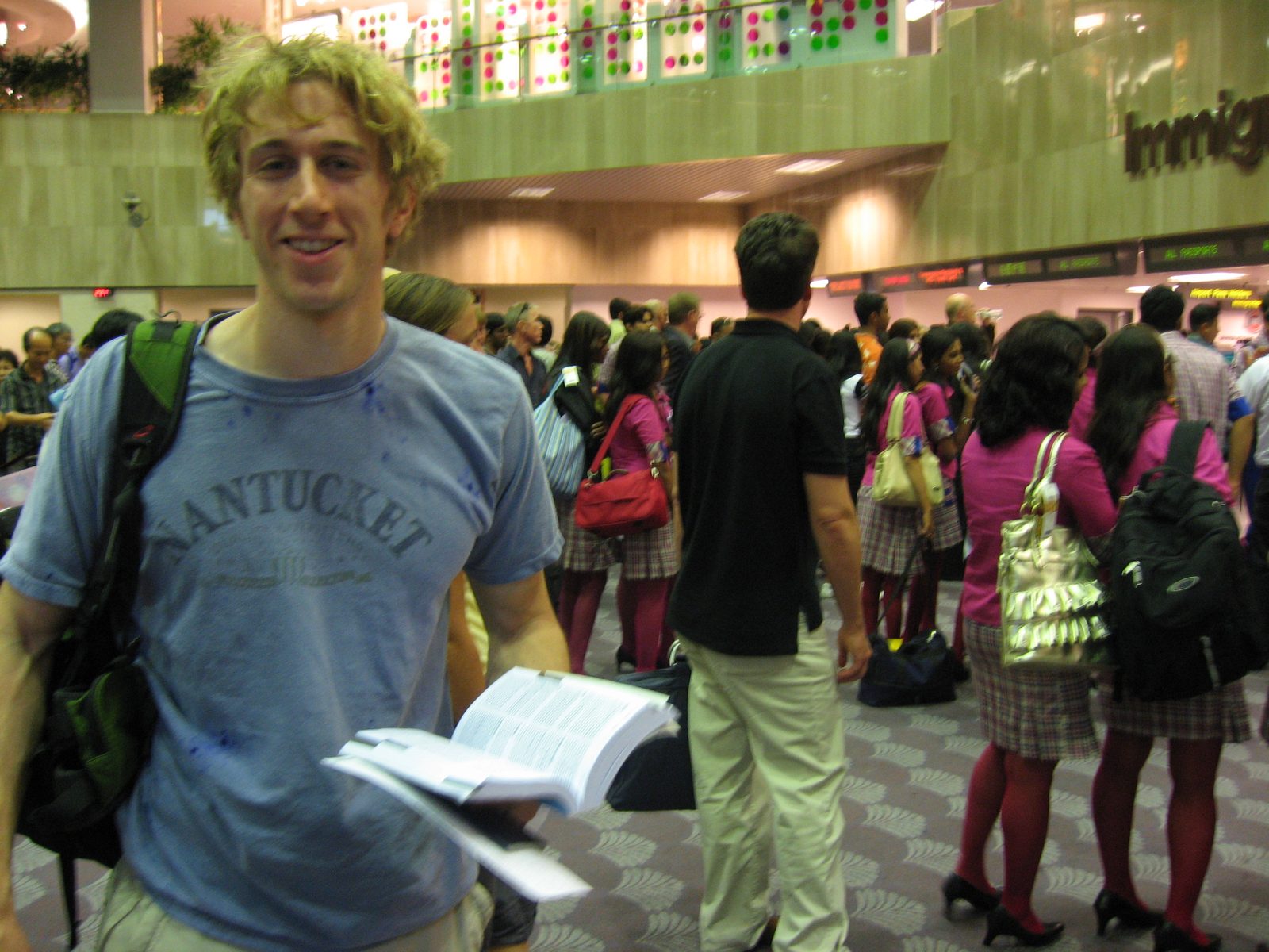 Trevor in line at immigration Changi International Airport.  Notice the ridiculous fuscia school...