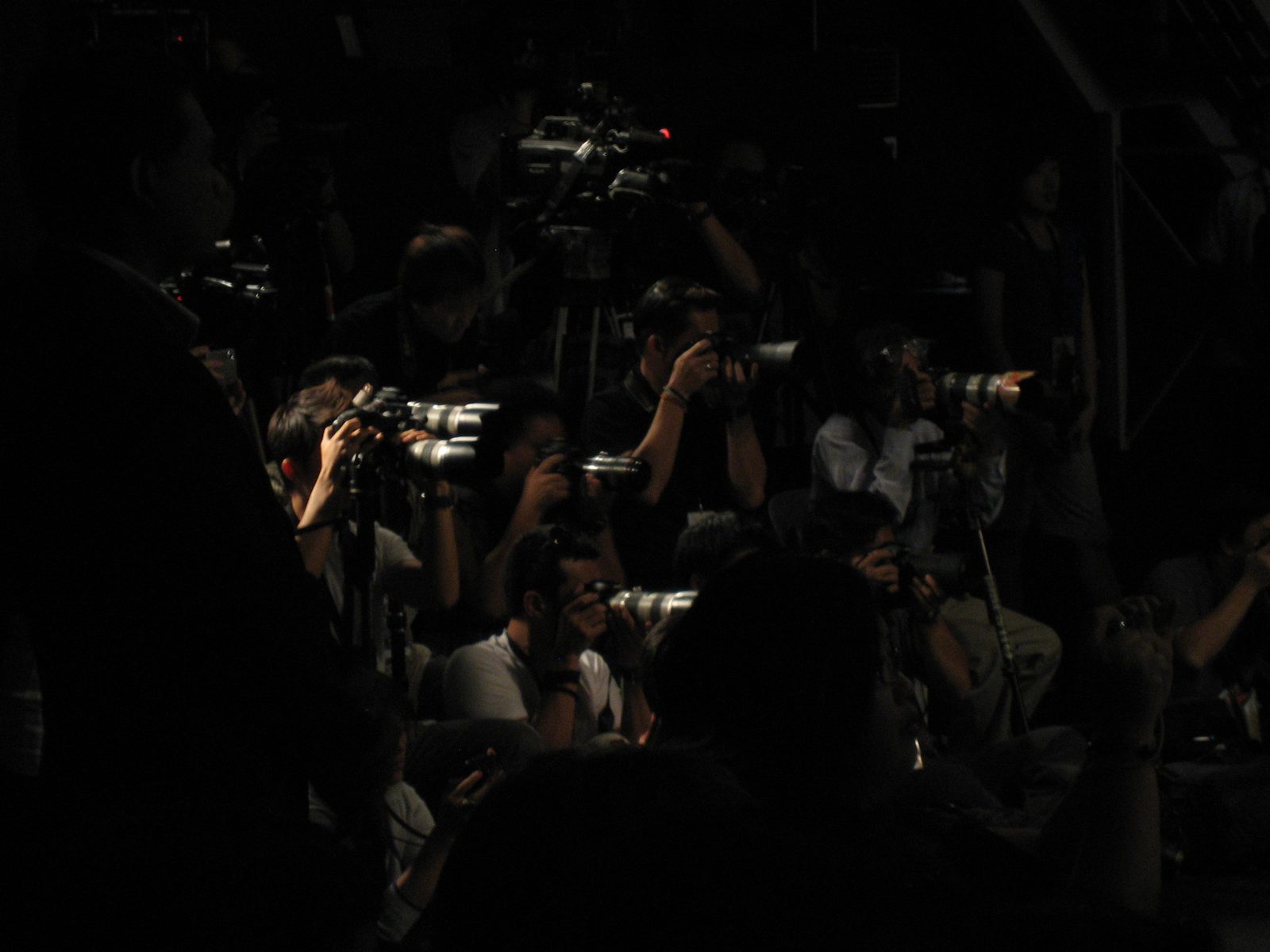 A lot of photographers were gathered for the fashion show.