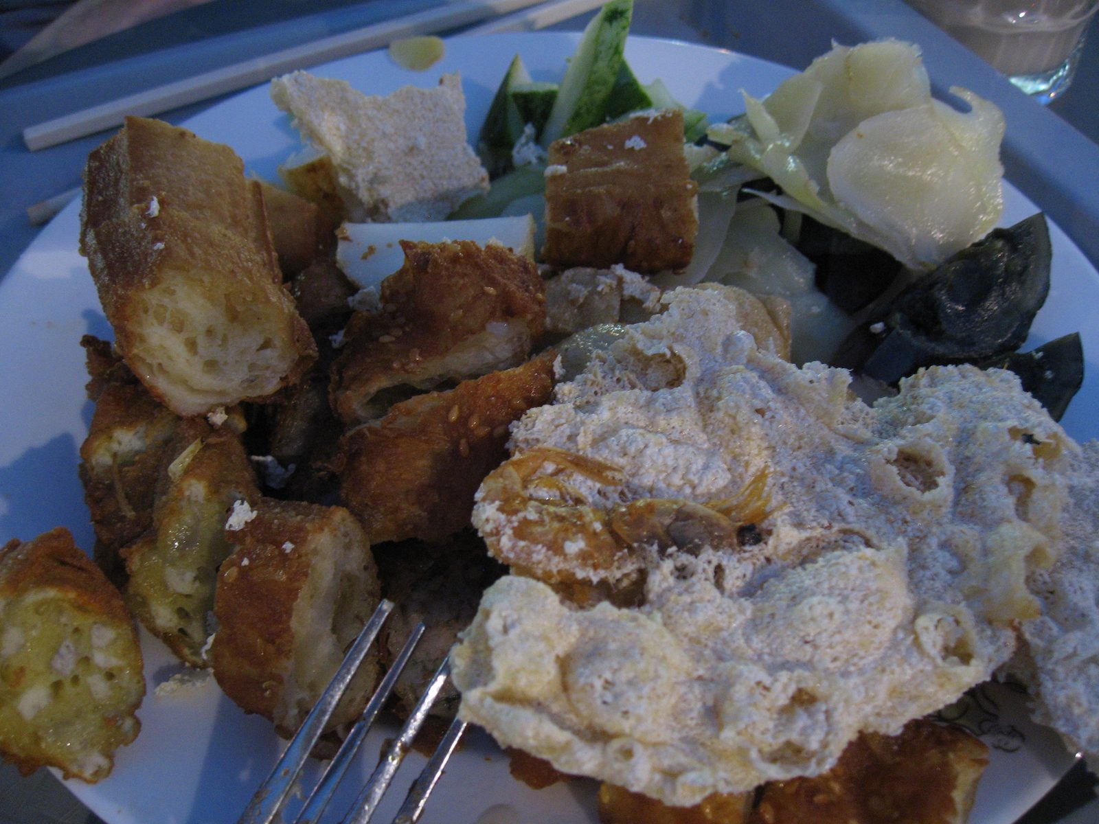 Whole shrimp embedded into roti bread, as well as banana fritters, tofu, ginger and some other...