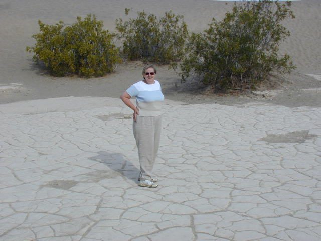 Mom on the cracked desert ground.