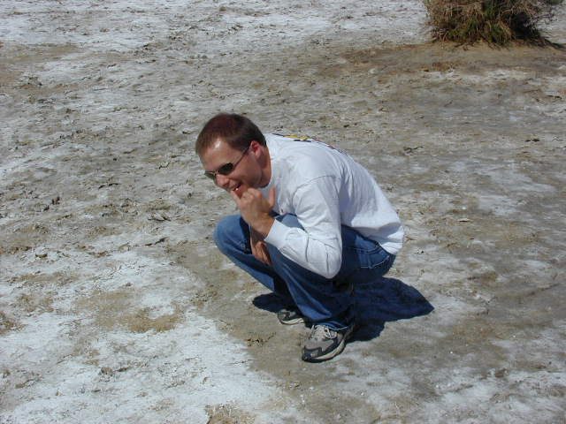John tastes the salt on the salt flats near Devil's Corn Field (?) in Death Valley.