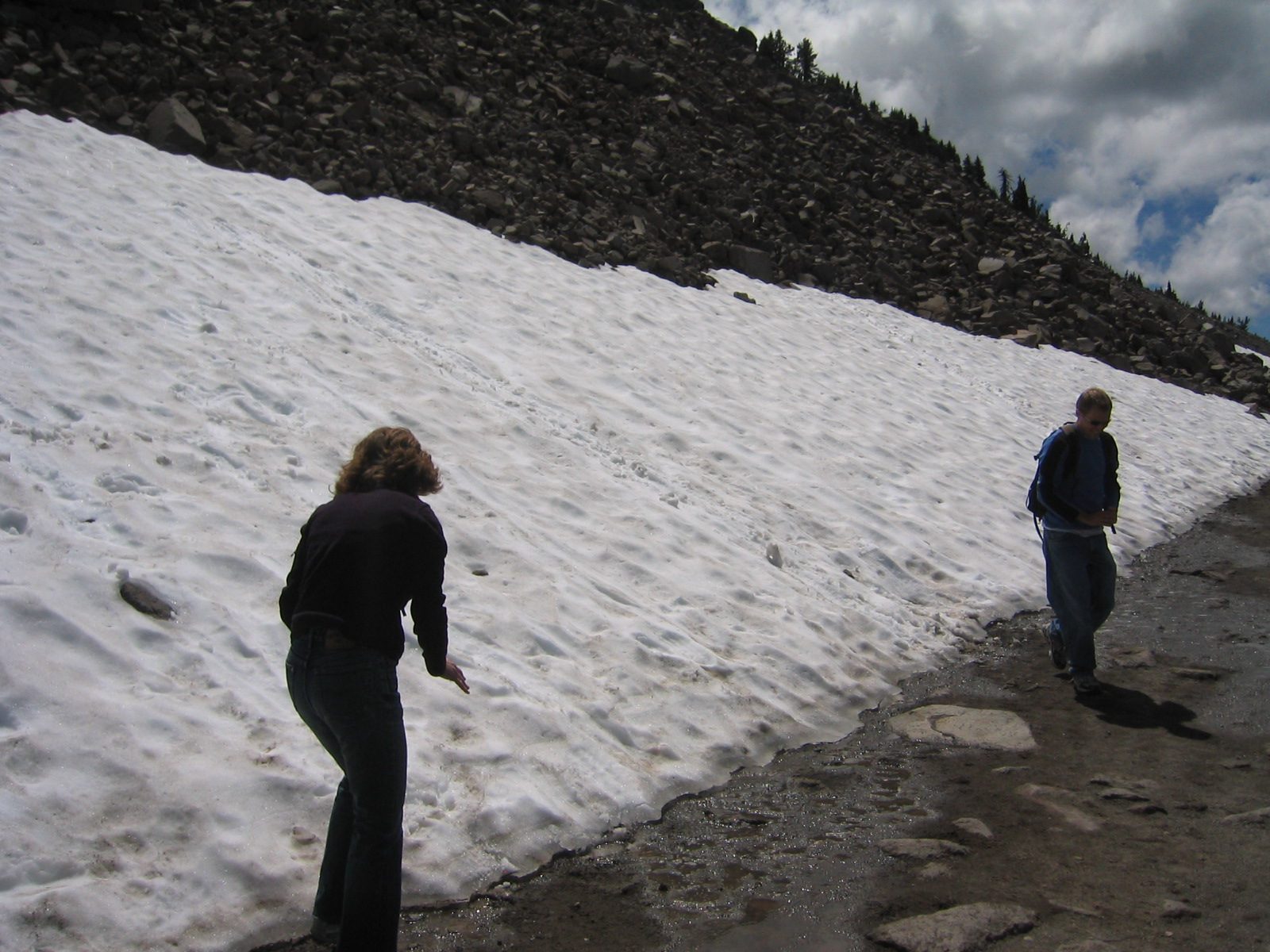 Alison and John playing on a snow field near Crater Lake.