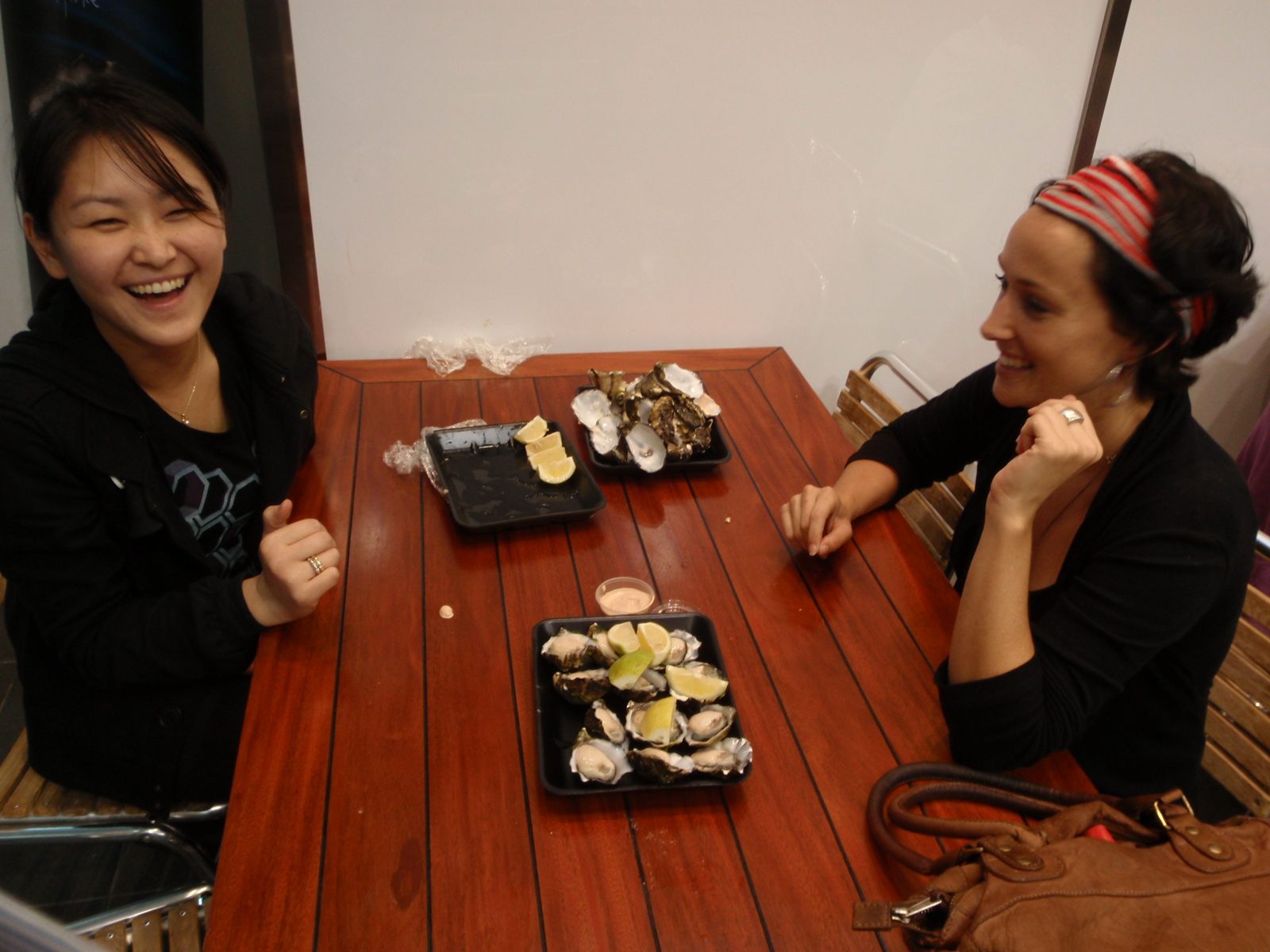 Monica and Louise taking a breather after eating the first dozen oysters.
