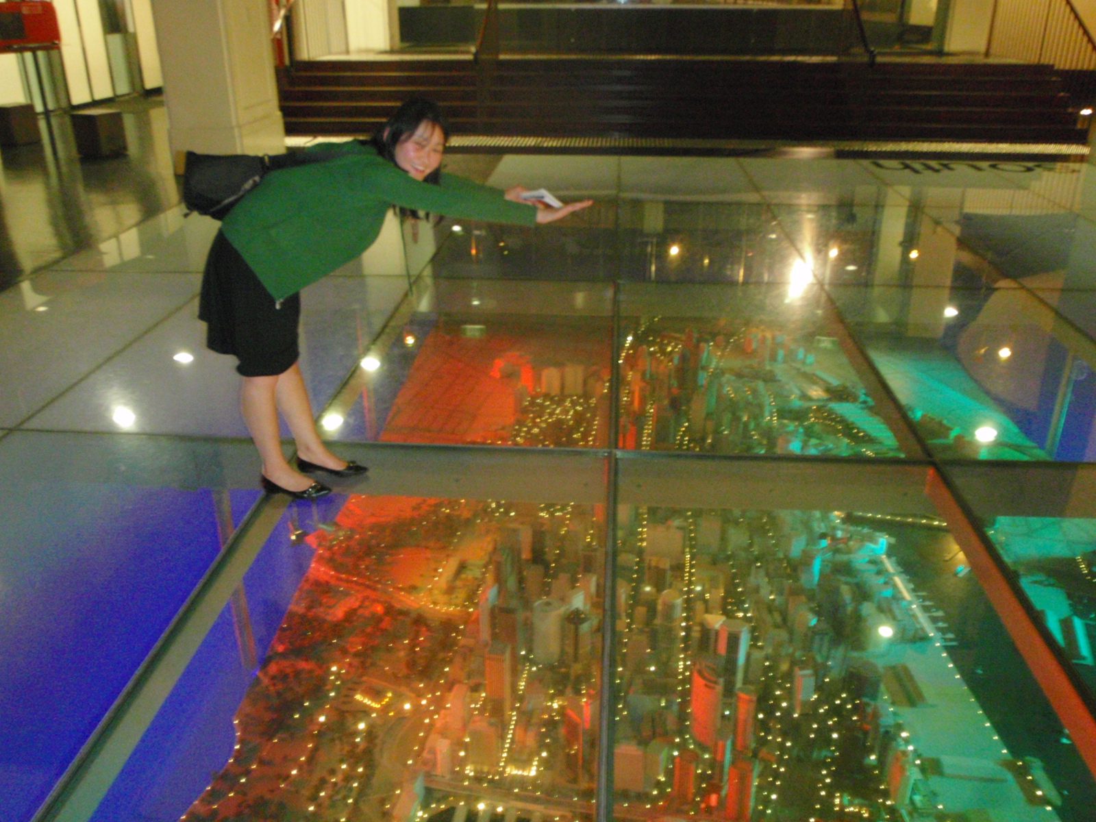 Monica superman flying over a model of Sydney under a glass floor in the lobby of the Customs building.