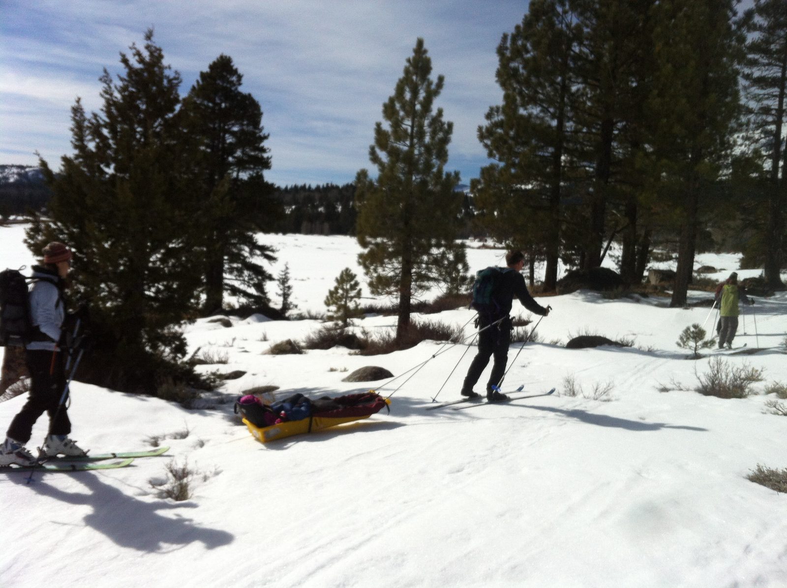 Dong (left) and Karla (right). Jim (center) tows baby Samara in our pulk, which is getting its...