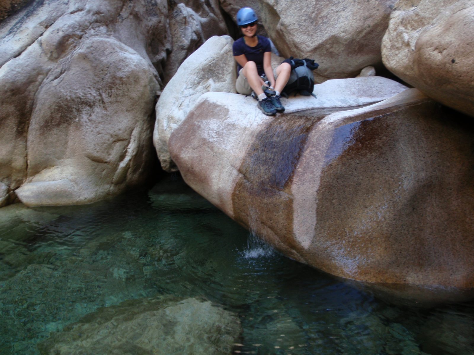 Monica, enjoying a short rest at the top of a miniature waterfall, just above the mouth of the...