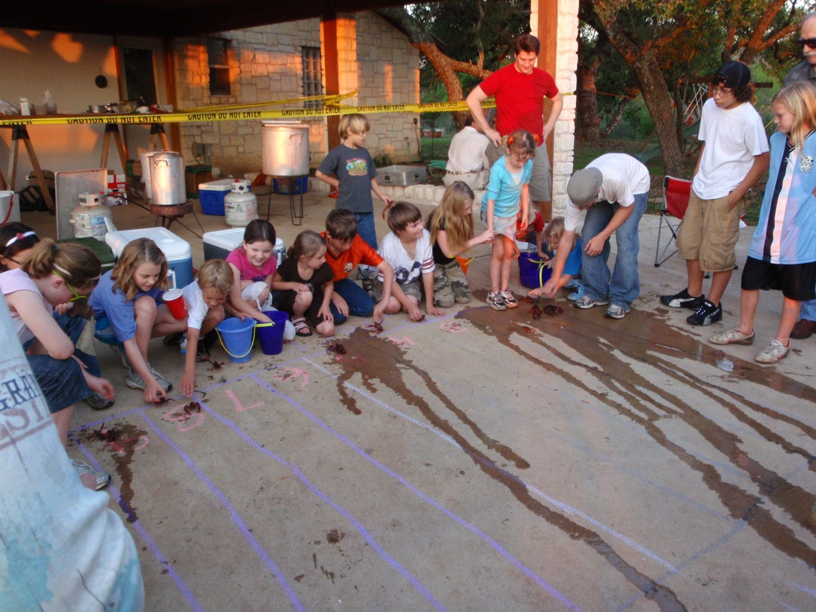 The kids line up to enter their contestants in the annual crayfish race.  They can jockey their...