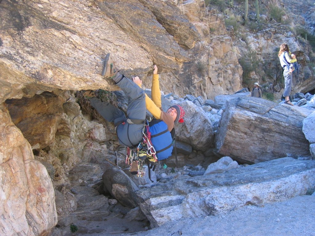 John messing around on a boulder in hiking boots.