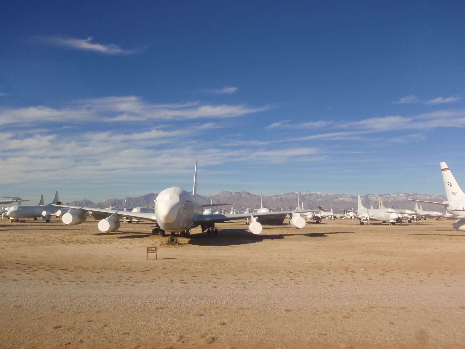Some four-engined aircraft covered in shrink wrap.