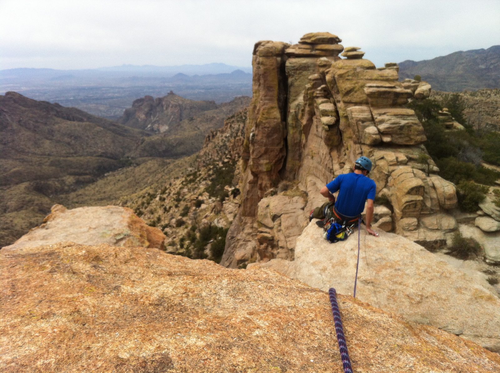 I give Ian a belay out to the edge of Swim Fin to set up a rappel.