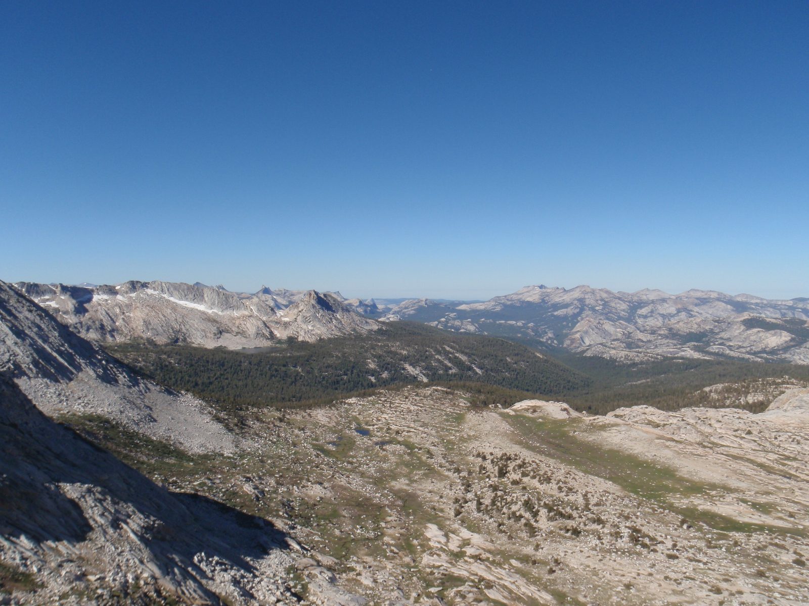 View from the base of the climb. Half Dome is plainly visible in the center, albeit small.