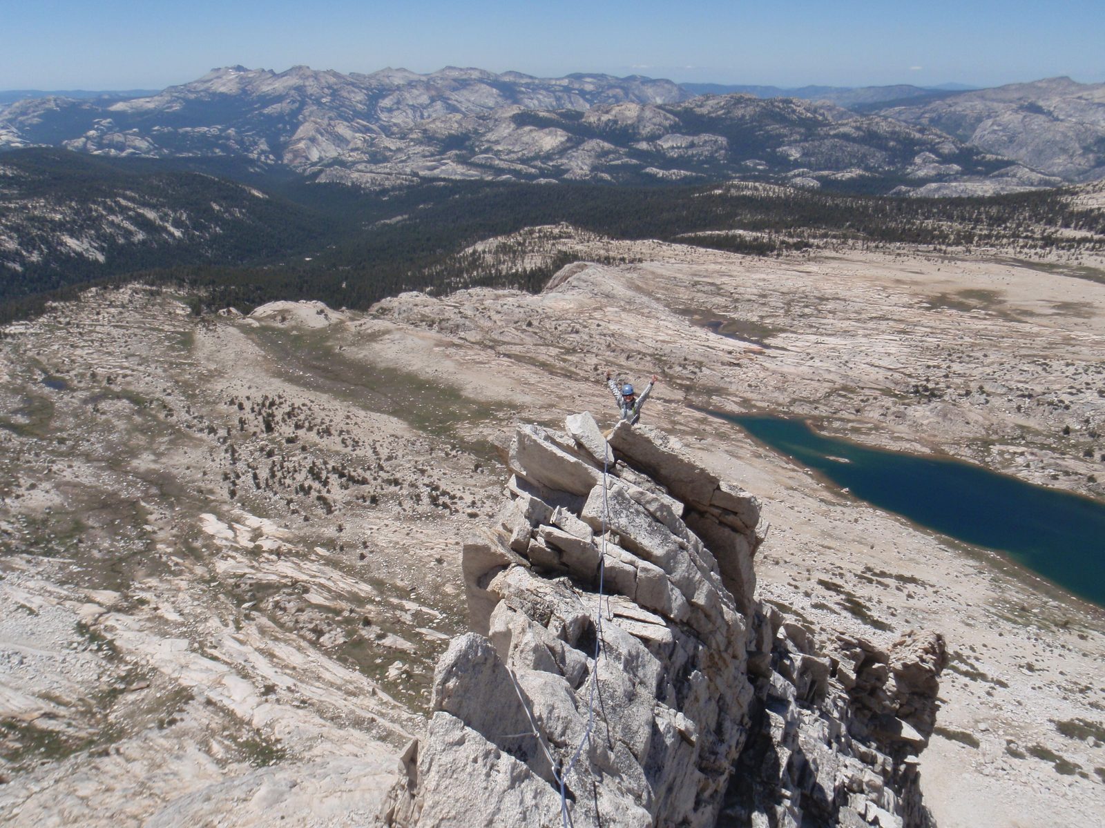 Monica, stoked on the knife-edge west Ridge of Mt. Conness. Roosevelt Lake in the background at...