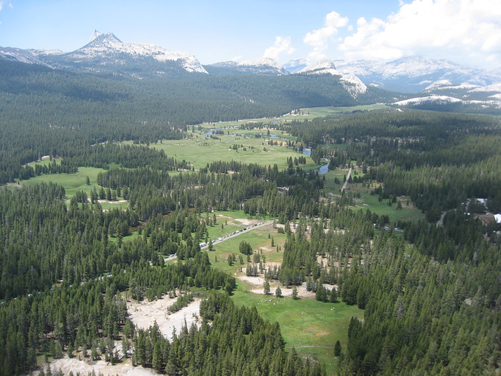 Enjoying the view of Tuolumne Meadows from midway up Lembert Dome. Cathedral Peak is in the...