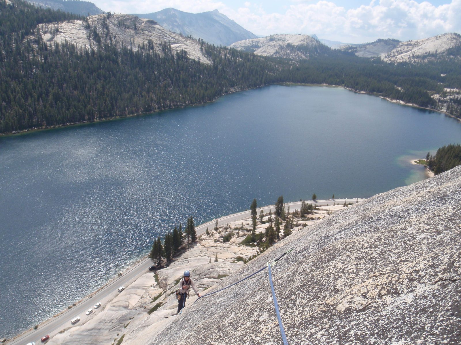 Monica climbs The Boltway (5.8) on Stately Pleasure Dome above beautiful Tenaya Lake.