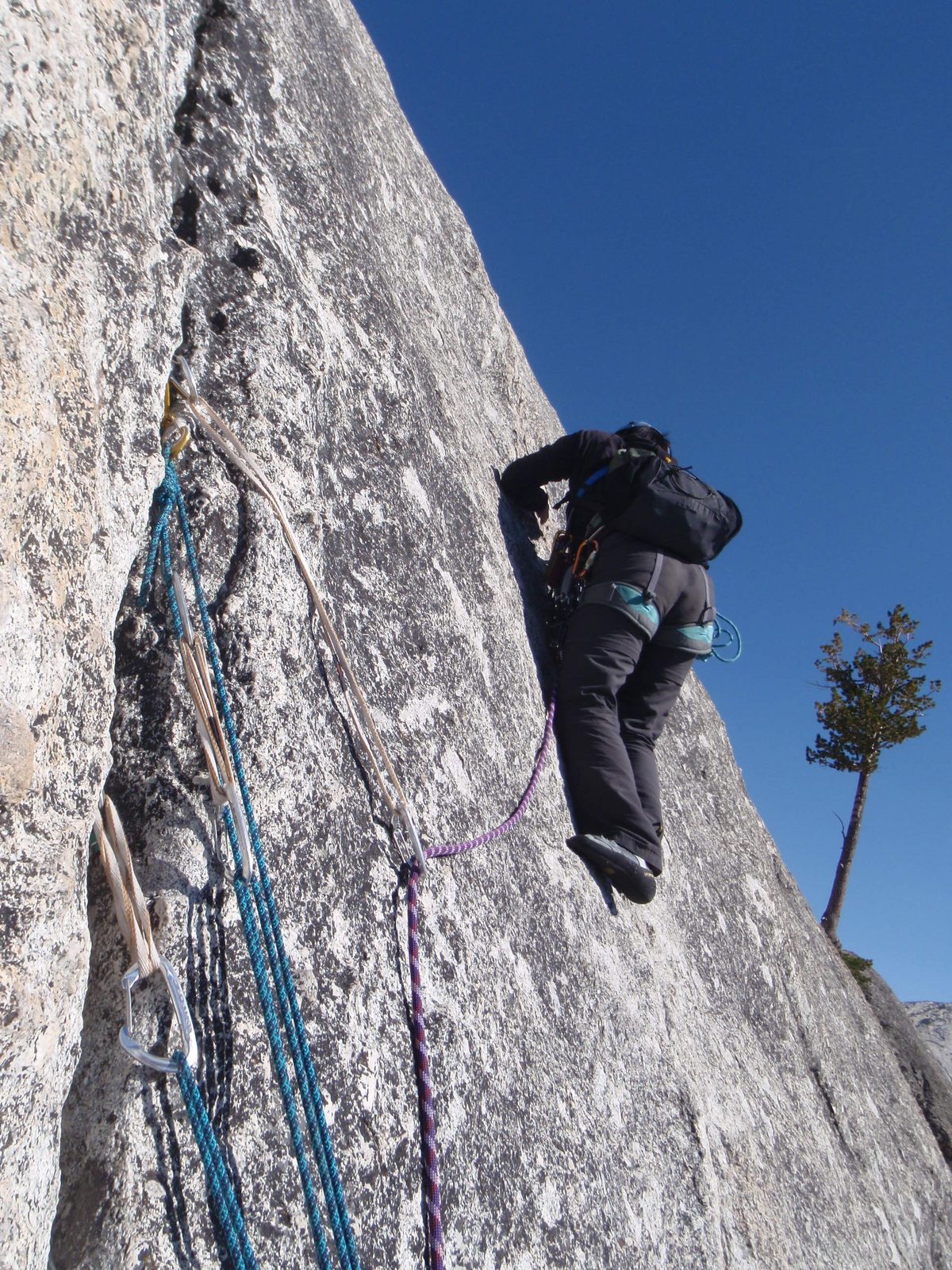 Monica placing some gear on the fourth pitch of West Crack (5.9). 