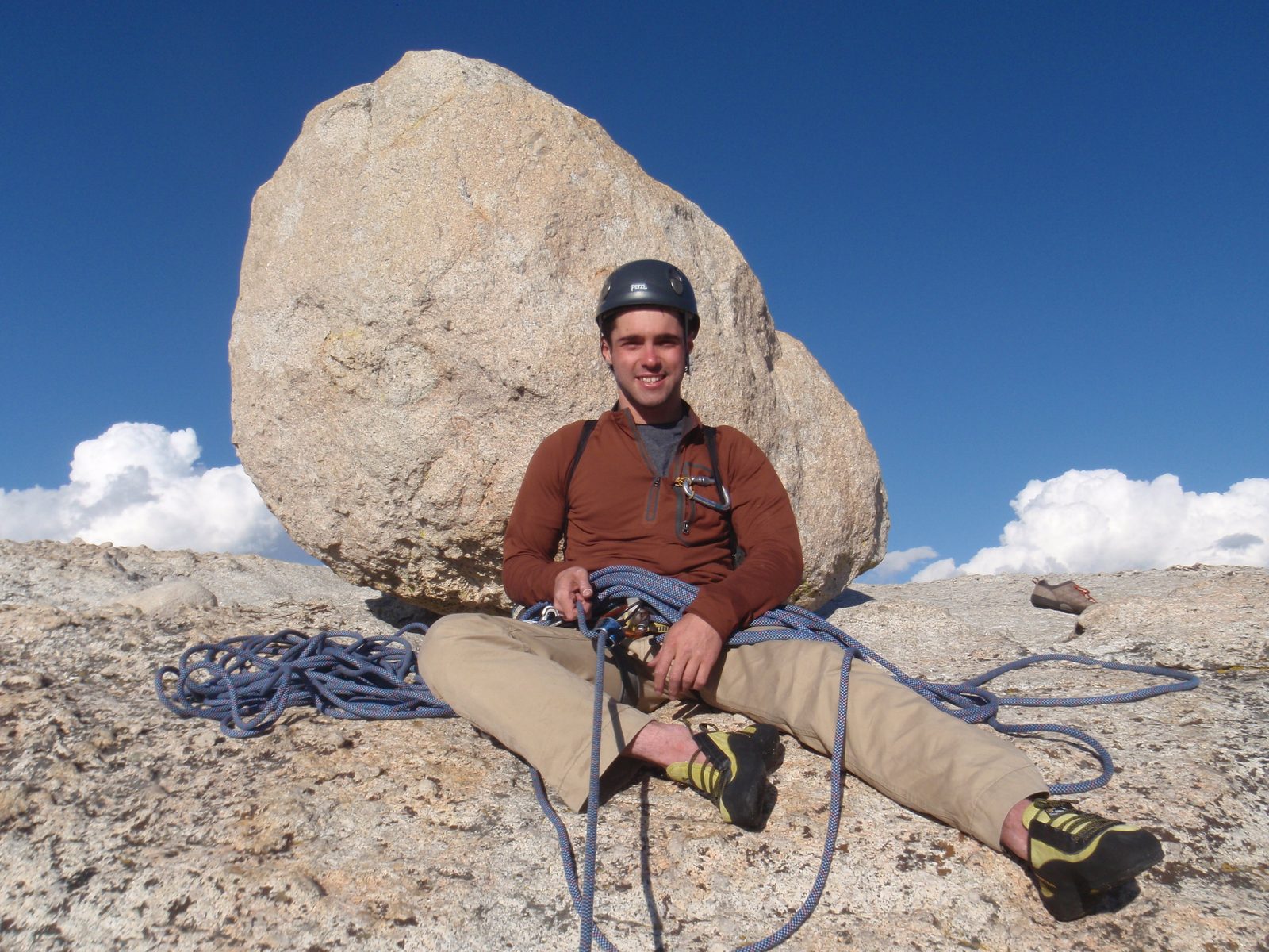 Alex, triumphantly perched atop DAFF Dome, anchored to an enormous erratic boulder, as he belays...