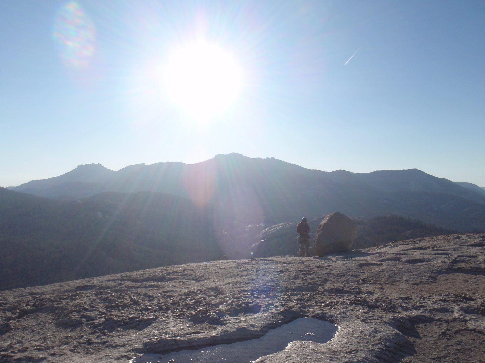 Alex packs up gear. Evidence of the recent massive amount of rain is shown in the potholes:...