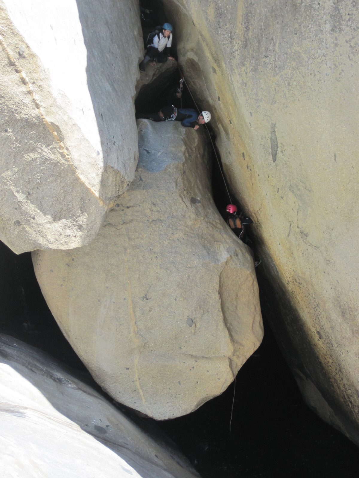 Aditi on the first rappel. Tracy and Colin watch from above.